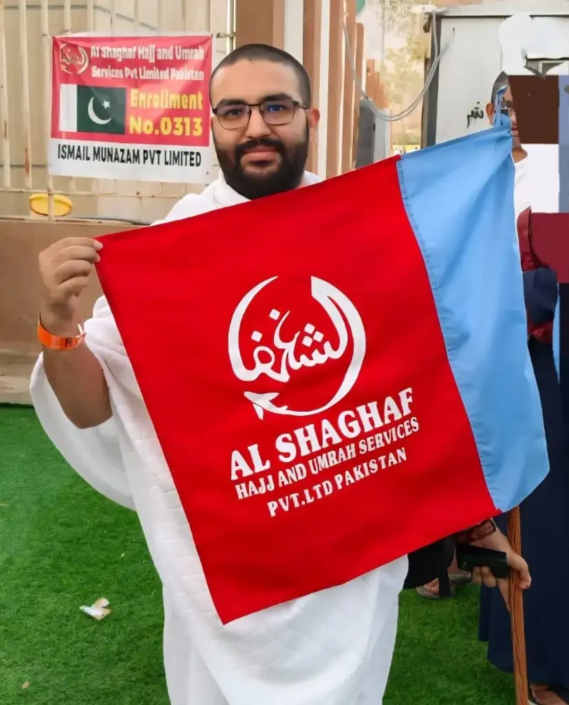 Our Happy Pilgrims Standing in Arafat Holding the Flag of Al Shaghaf